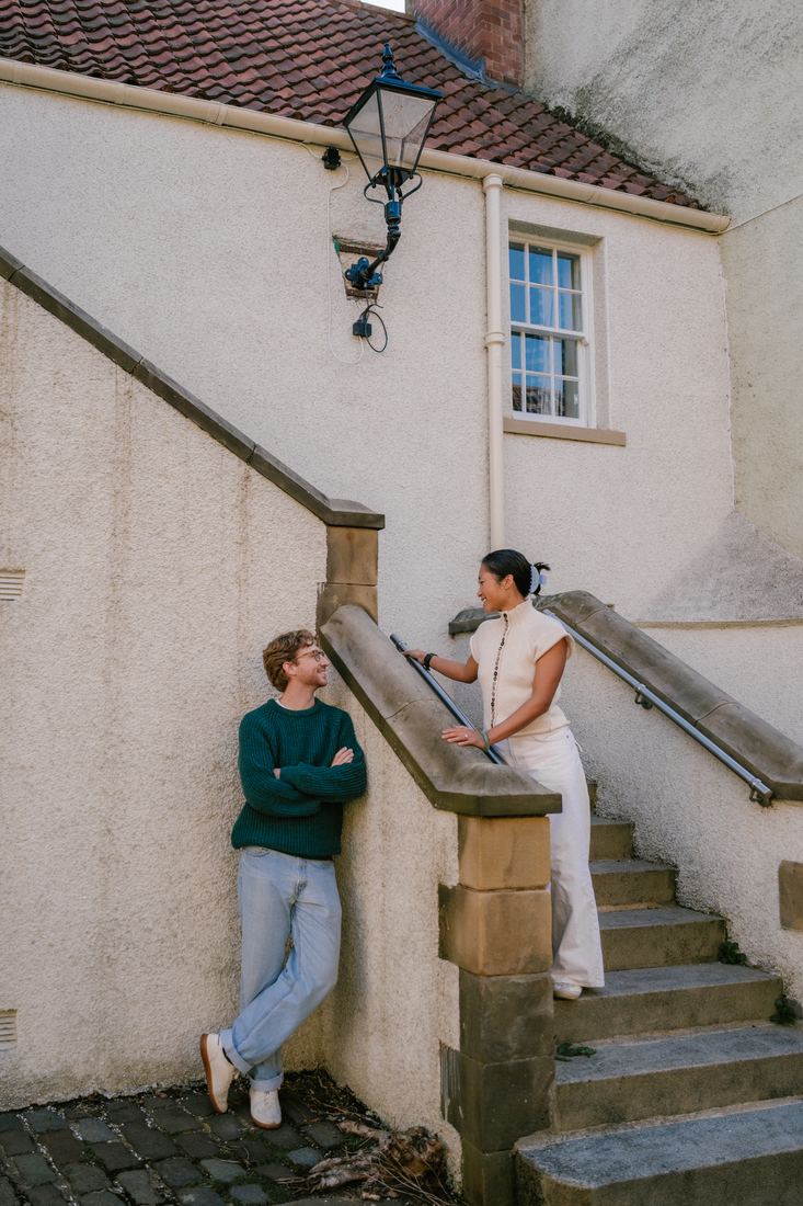 Couple on white steps in an Edinburgh close